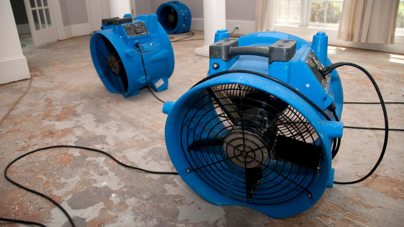 Structural drying with industrial air movers and floor drying after indoor water damage