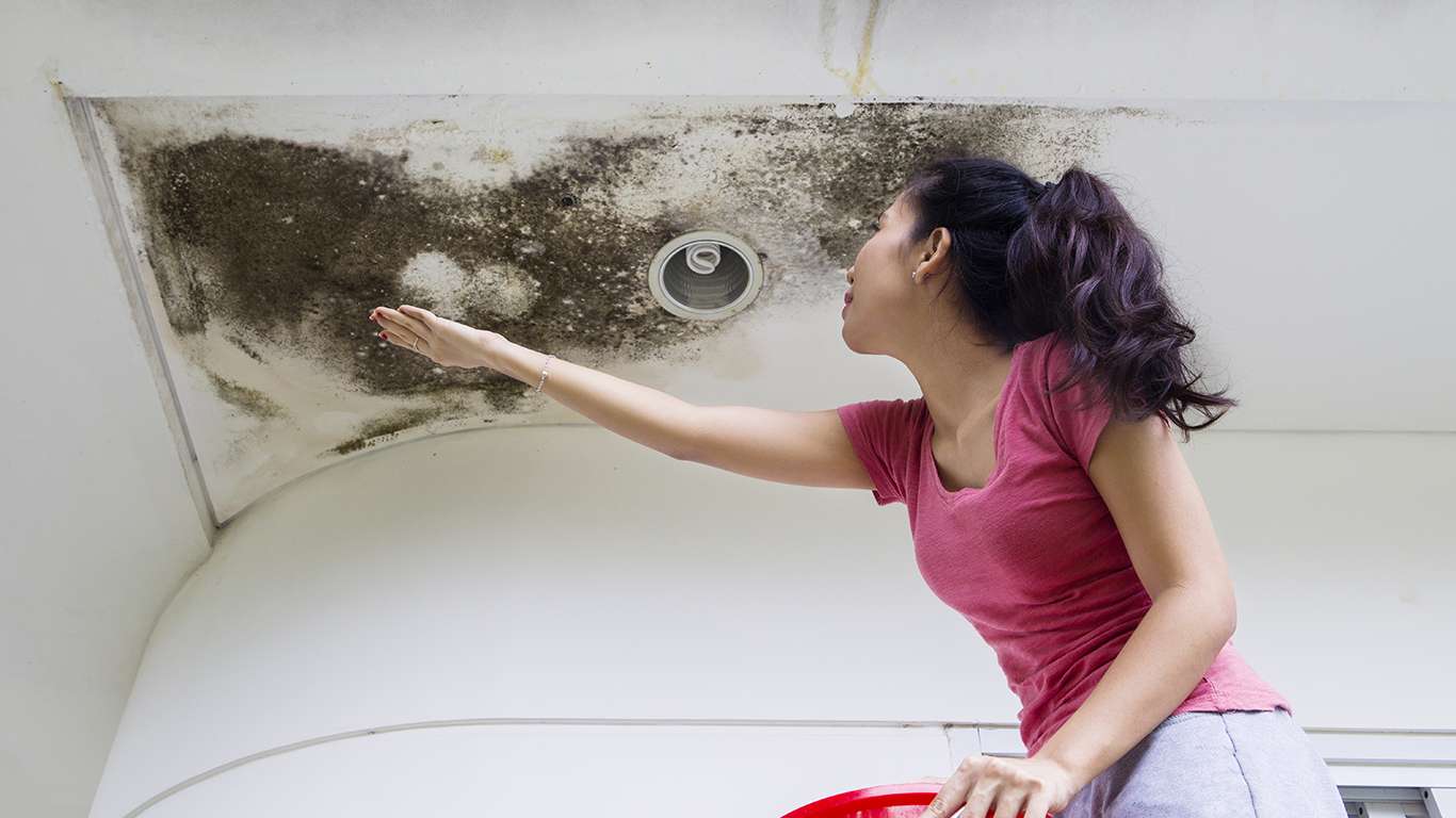 Woman collecting drop rainwater with her hand