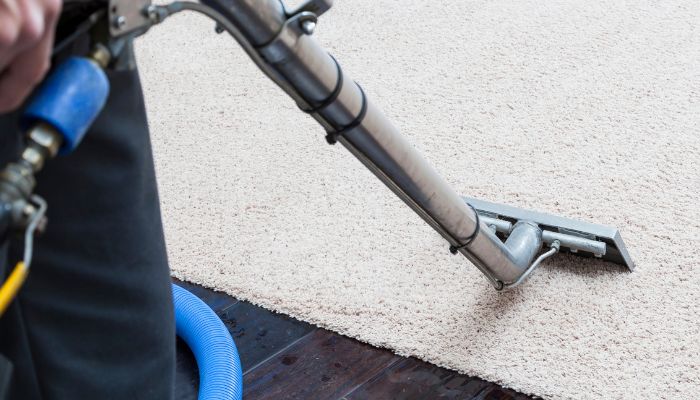 vacuum cleaning the carpet - Estero odor removal