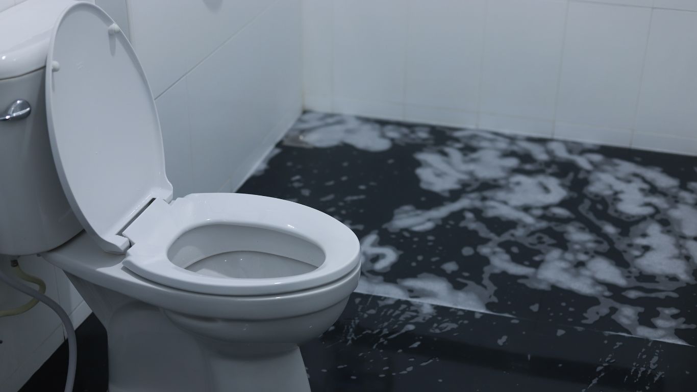 Why Sewage Cleanup Is Not a DIY Job and What to Do Instead Overflowed bathroom toilet with contaminated water on floor requiring professional sewage cleanup