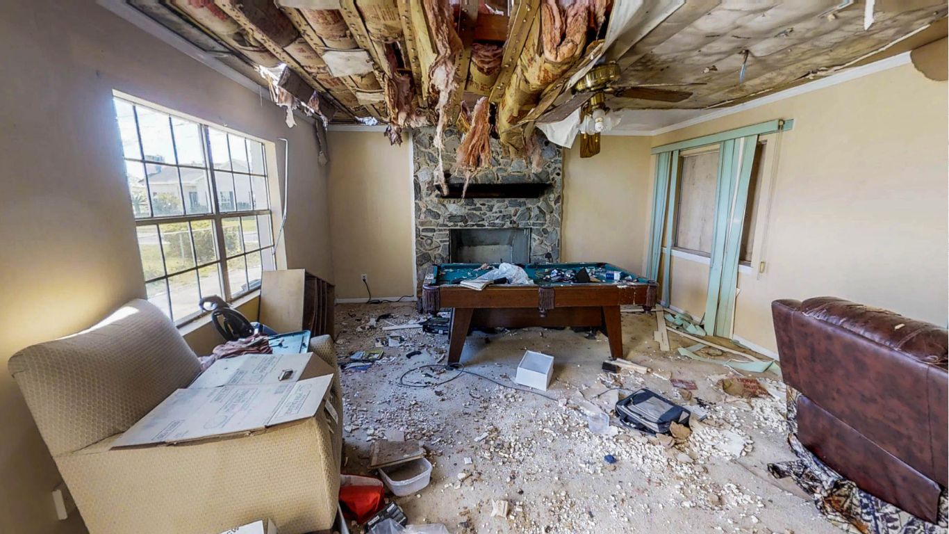 Storm damage restoration in New Orleans with severe ceiling and wall damage from a storm.