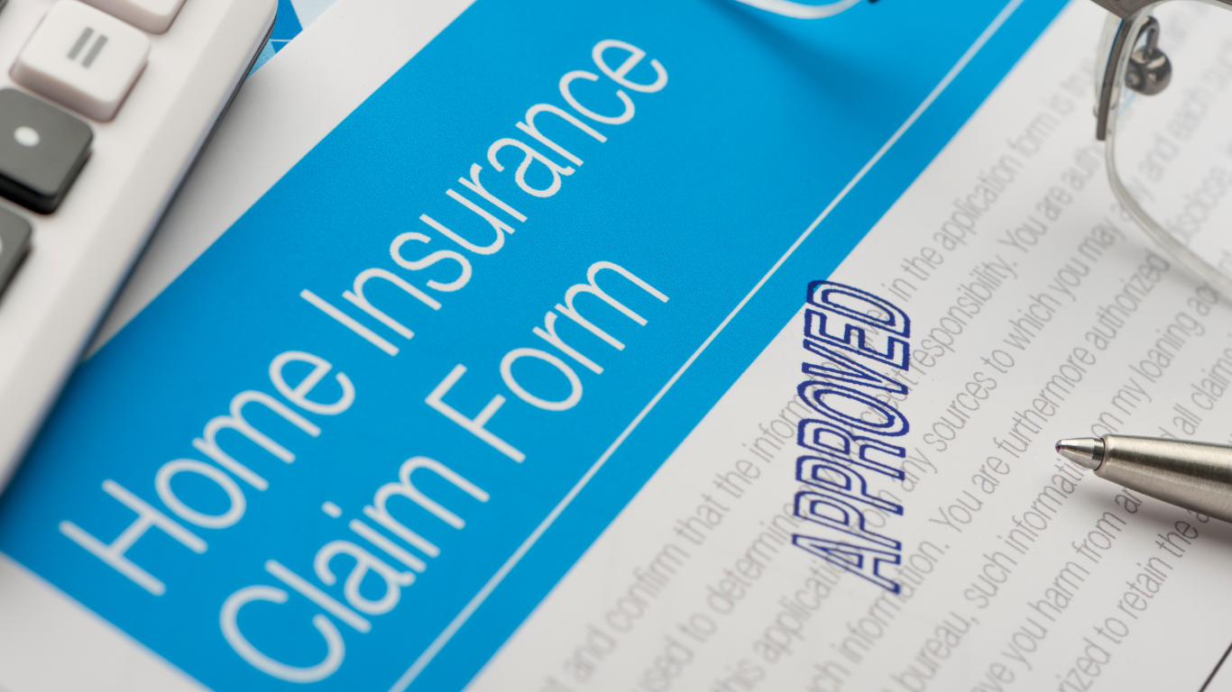 Insurance Tips for Water Damage Claims in the Bluegrass Area Approved home insurance claim form with pen and glasses, representing insurance tips for water damage claims.
