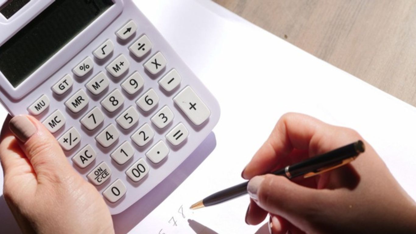 How Much Does Professional Leak Detection in Bolingbrook Cost Close-up of a person using a calculator writing down how much is Professional Leak Detection in Bolingbrook Cost